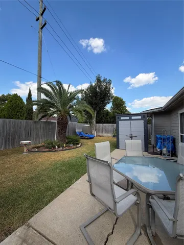 a view of a backyard with plants and outdoor seating