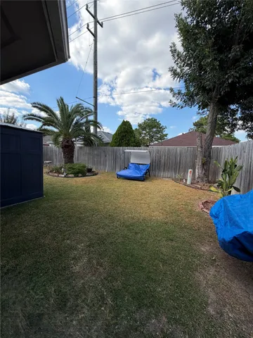 a living room with furniture and a dining table with wooden floor