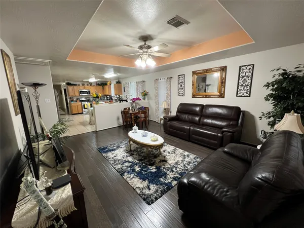 a view of a hallway with wooden floor and entryway