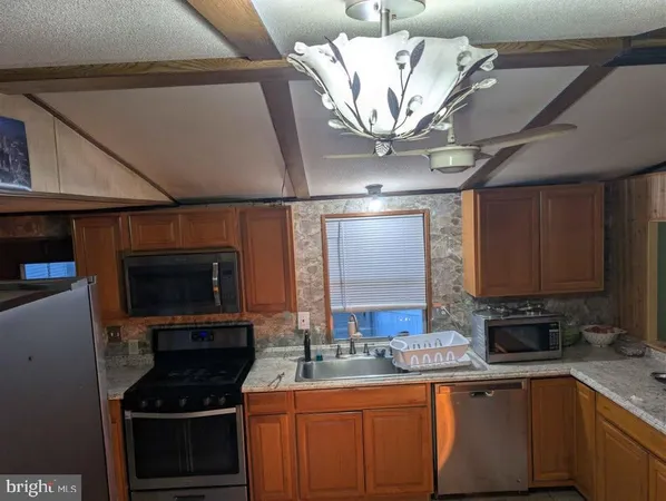 a kitchen with stainless steel appliances granite countertop a stove and a sink