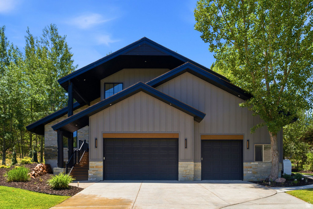 3027 Homestead Road Park City, UT 84098 - Photo 52 of 62 Contemporary exterior featuring vertical siding, stone accents, and a multi-gabled roofline