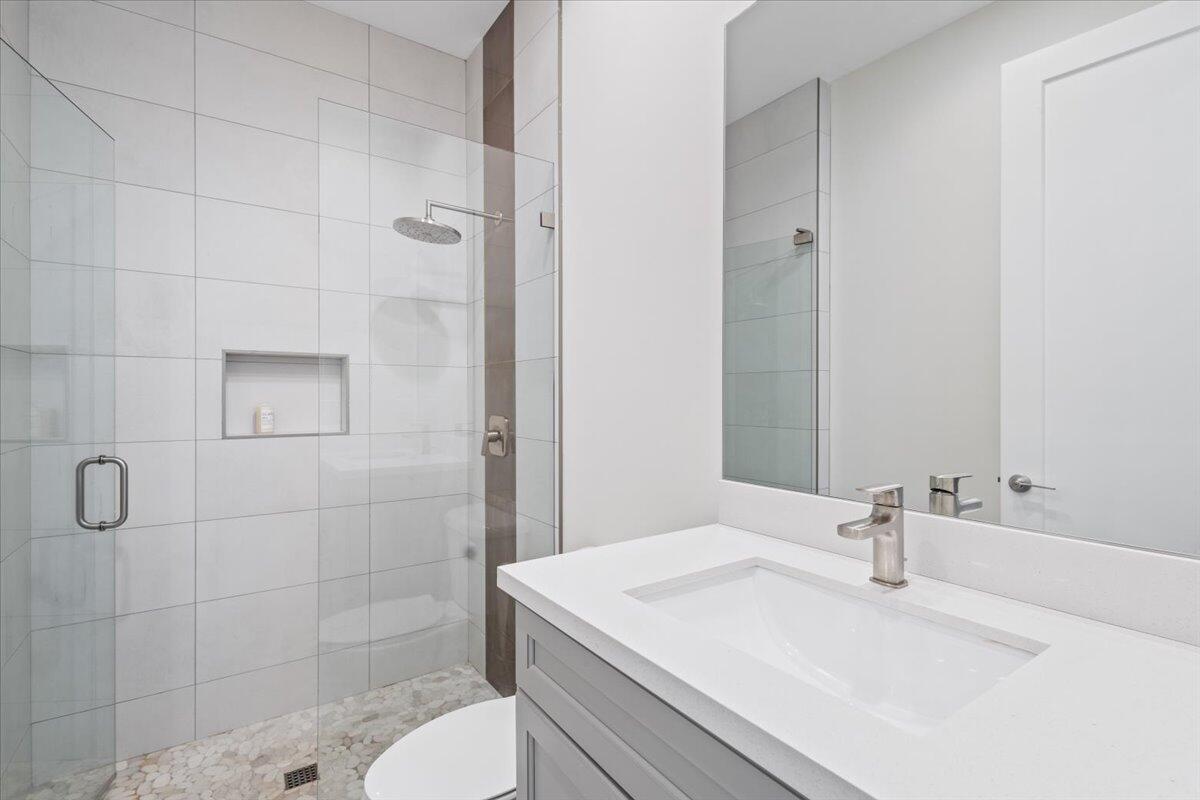 15377 Green River Court Delray Beach, FL 33446 - Photo 18 of 49 a bathroom with a sink a toilet and shower