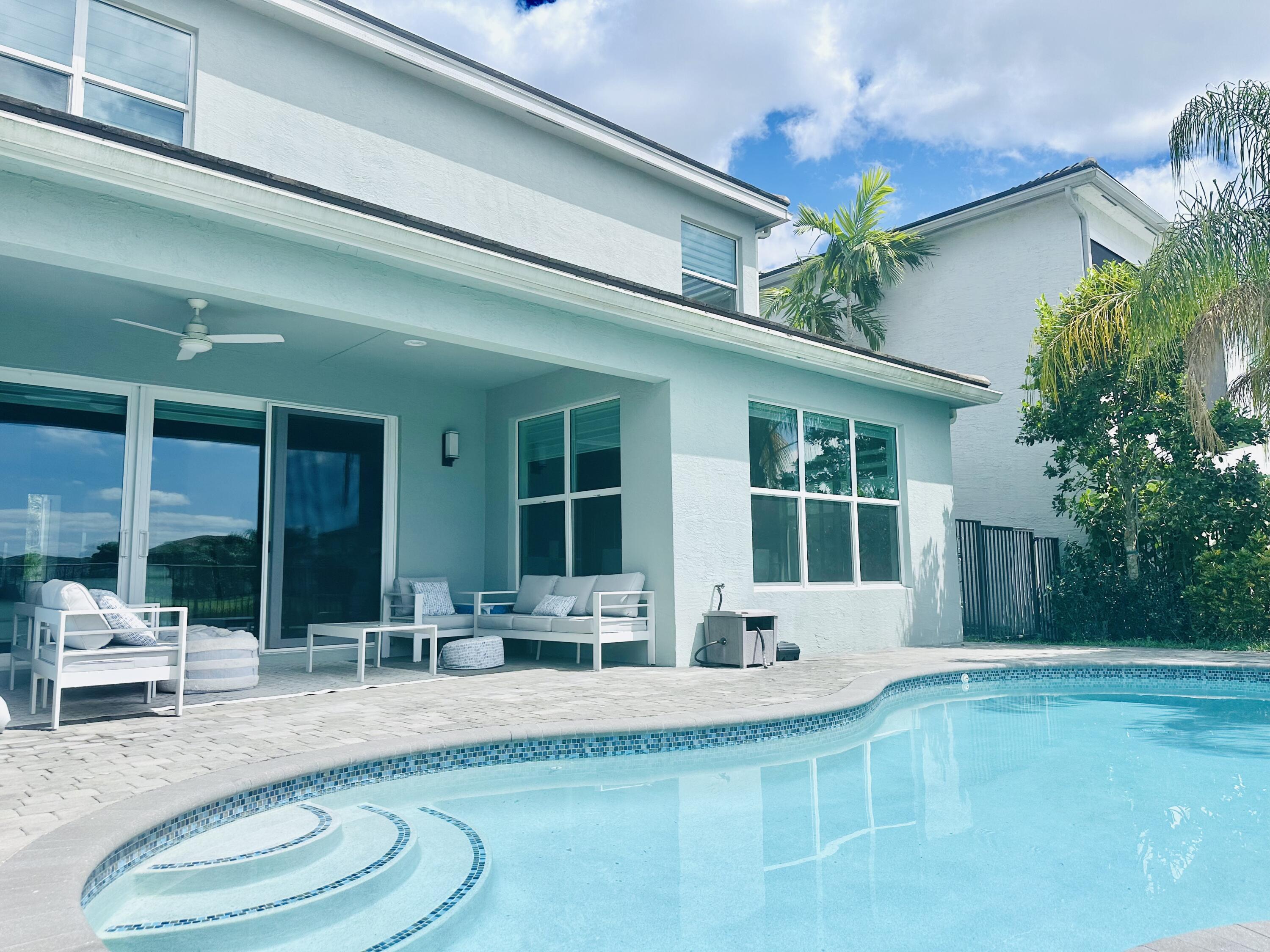 15377 Green River Court Delray Beach, FL 33446 - Photo 36 of 49 a swimming pool with outdoor seating and yard