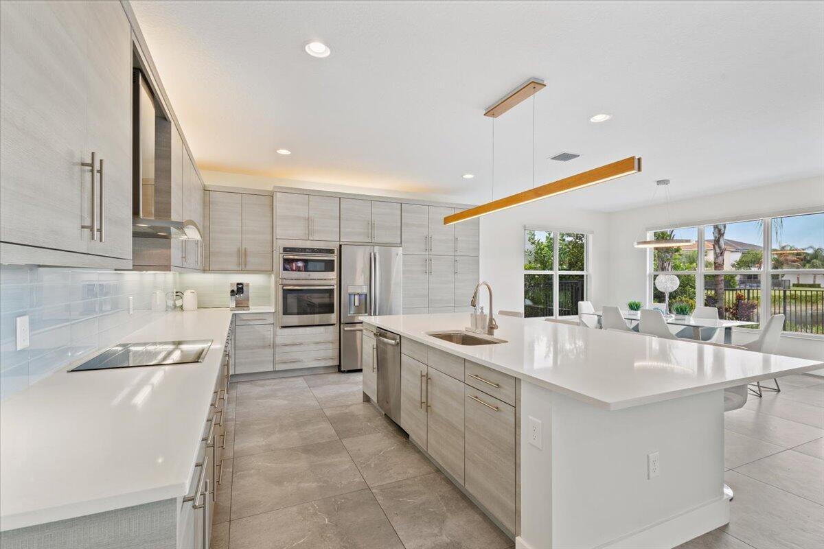 15377 Green River Court Delray Beach, FL 33446 - Photo 7 of 49 a large white kitchen with a large window
