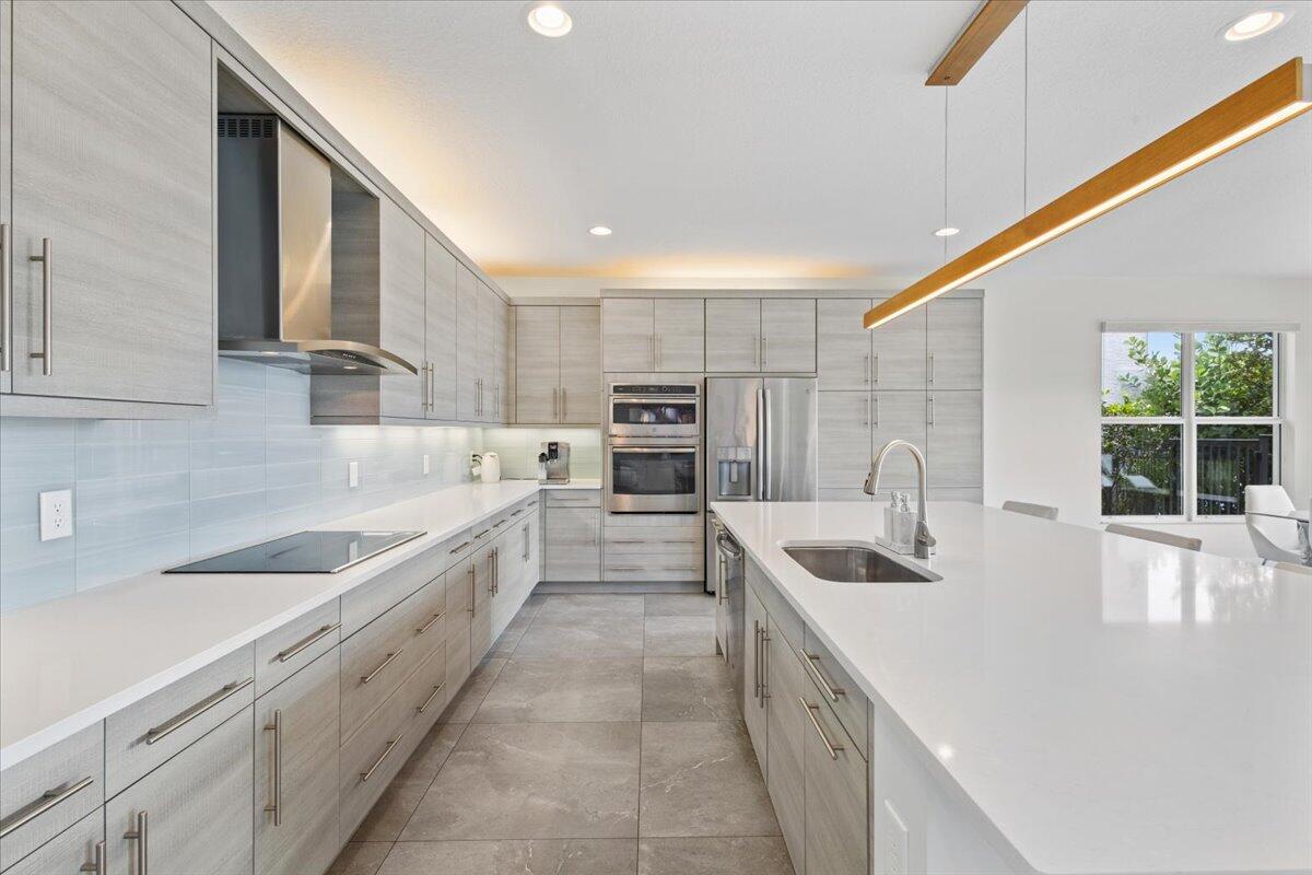 15377 Green River Court Delray Beach, FL 33446 - Photo 8 of 49 a large kitchen with granite countertop a sink and white cabinets