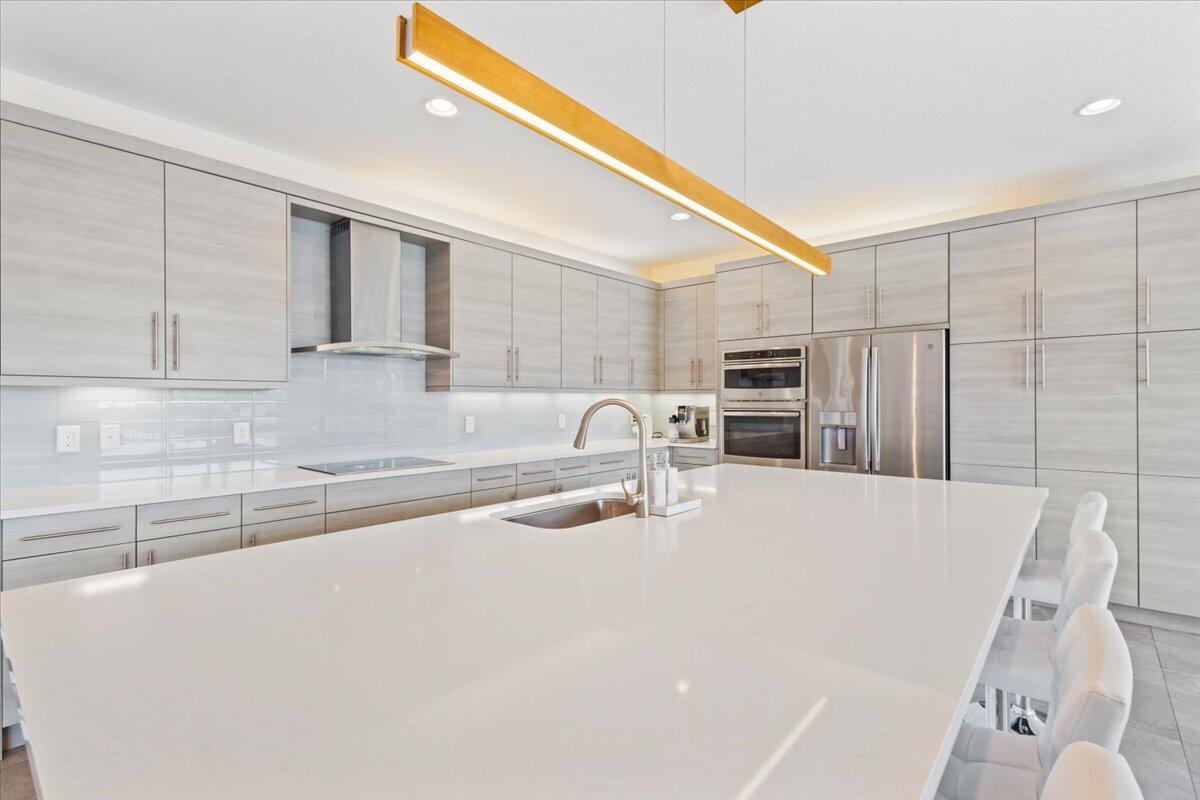 15377 Green River Court Delray Beach, FL 33446 - Photo 9 of 49 a kitchen with stainless steel appliances a refrigerator sink and cabinets