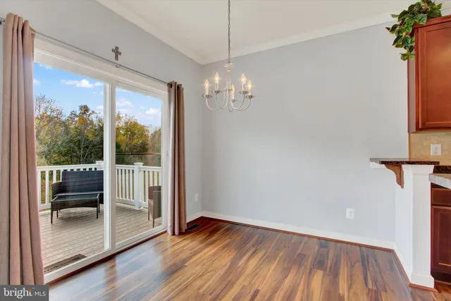 a view of a room with wooden floor and outdoor view
