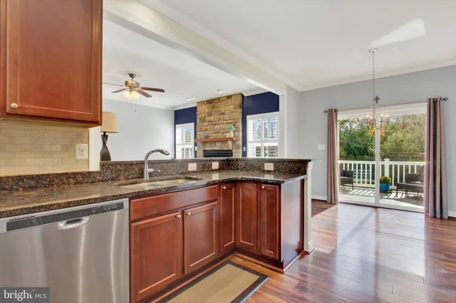 a kitchen with stainless steel appliances a stove microwave and sink