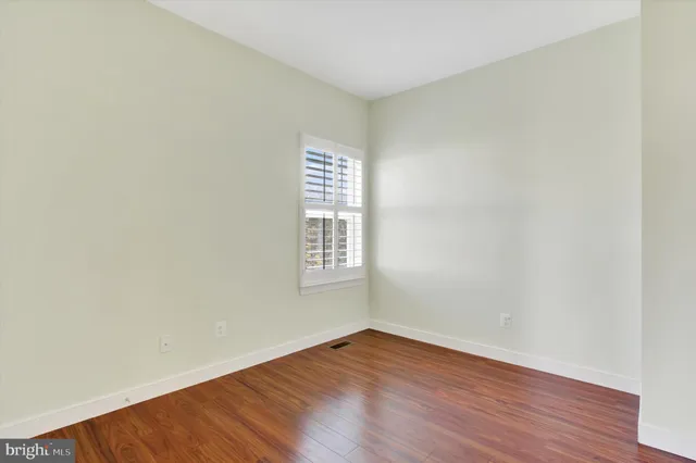 a bathroom with a sink a toilet a mirror and shower