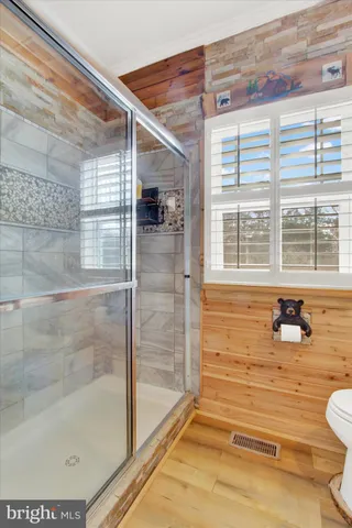 a bathroom with a shower and mirror