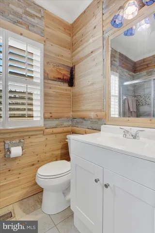 a living room with wooden floor and a window