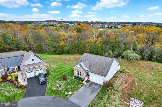 an aerial view of residential houses with outdoor space and river