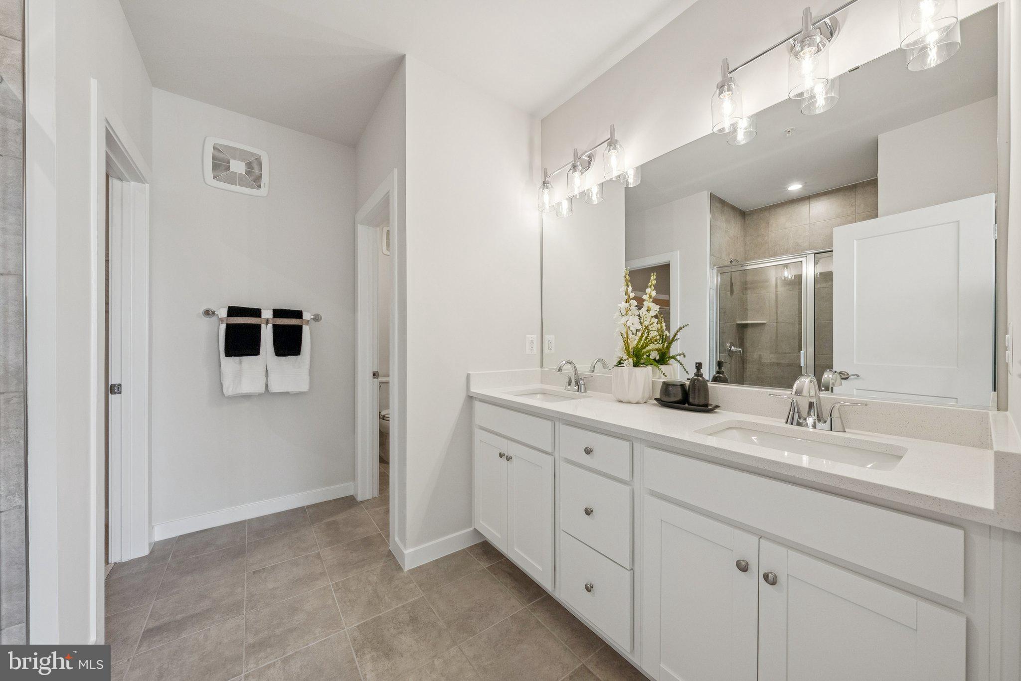8702 Lovelace Street Manassas, VA 20110 - Photo 21 of 27 a bathroom with a double vanity sink mirror and double