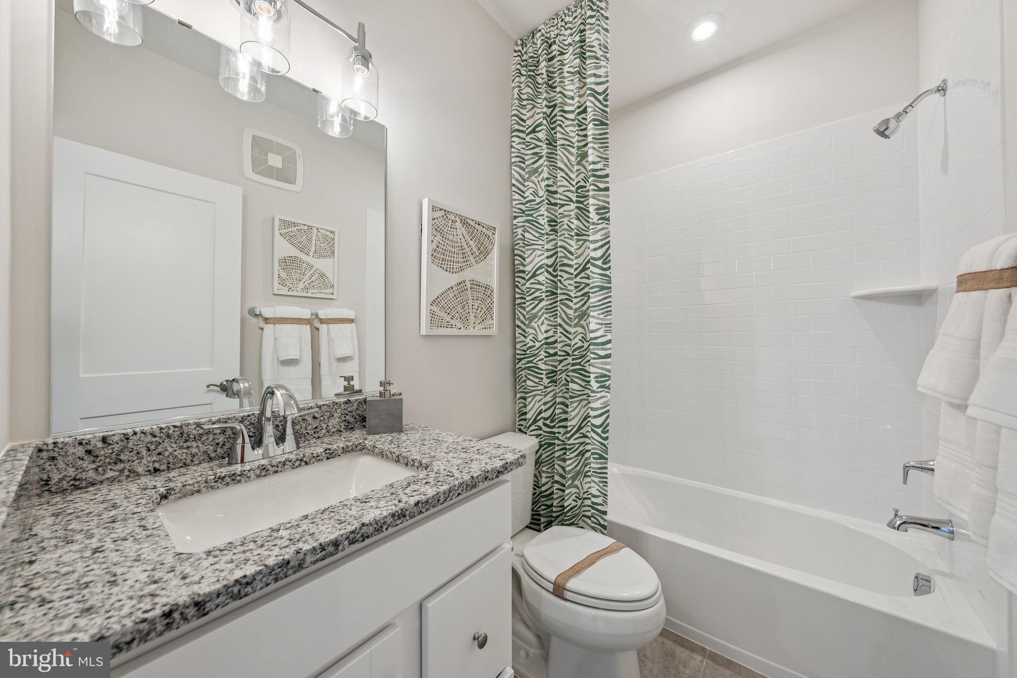 8702 Lovelace Street Manassas, VA 20110 - Photo 25 of 27 a bathroom with a granite countertop sink a toilet and bathtub