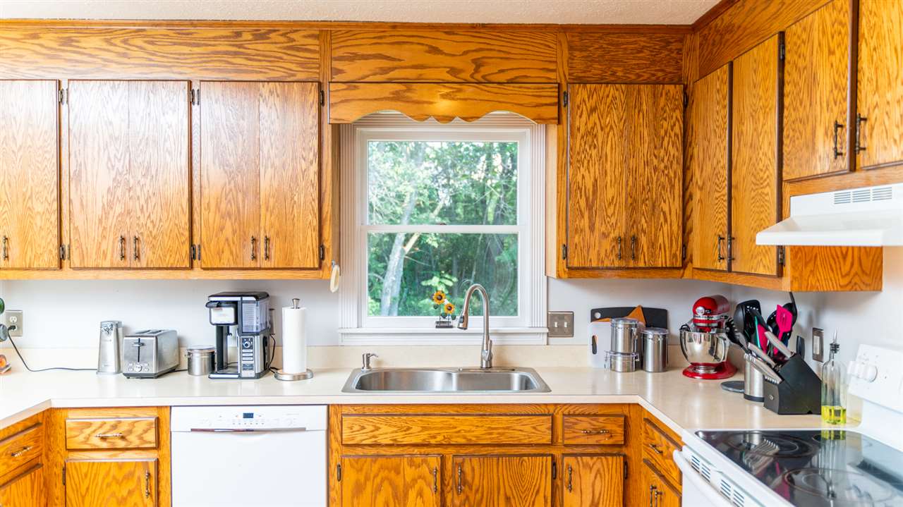 104 Buckboard Road Waynesboro, VA 22980 - Photo 14 of 43 a kitchen with a window a sink and a counter top space