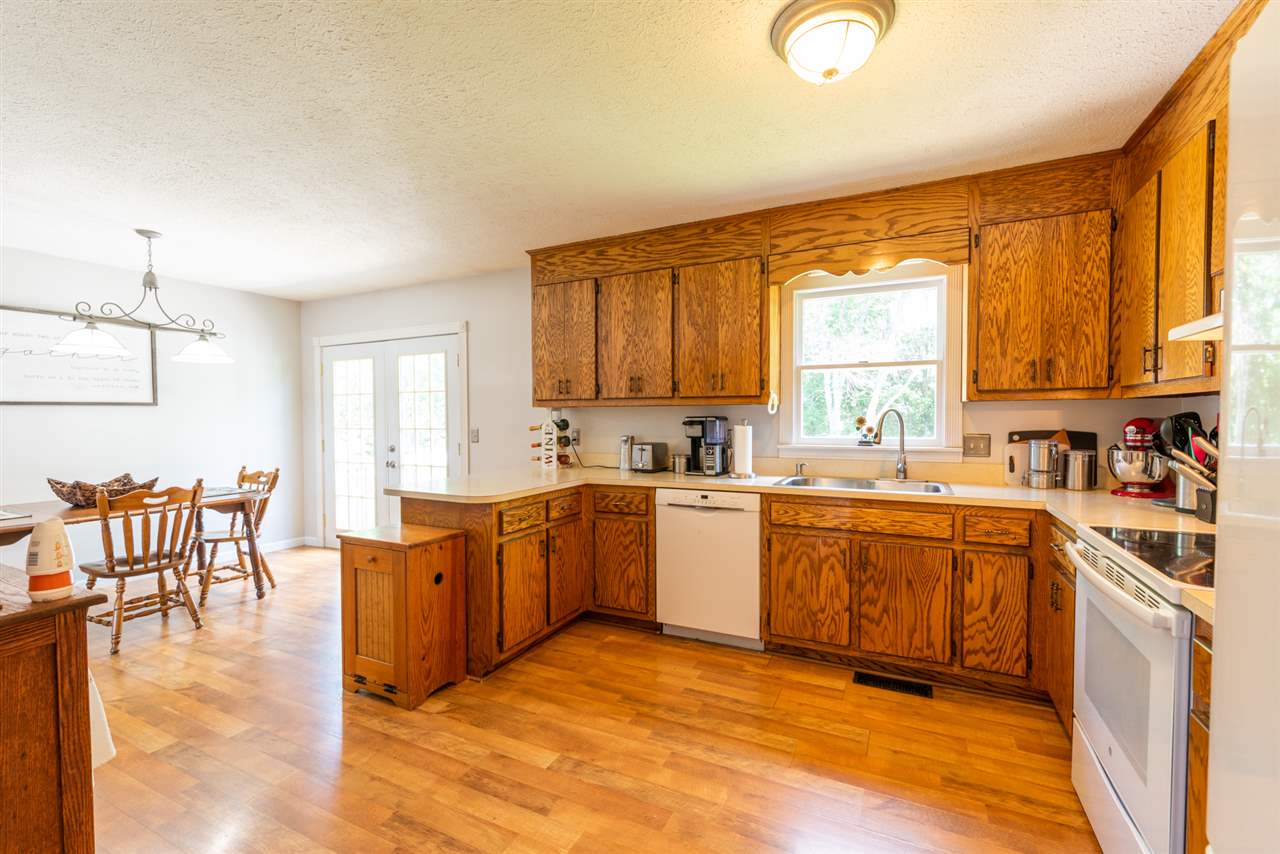104 Buckboard Road Waynesboro, VA 22980 - Photo 16 of 43 a large kitchen with stainless steel appliances granite countertop a stove a sink a dining table and chairs