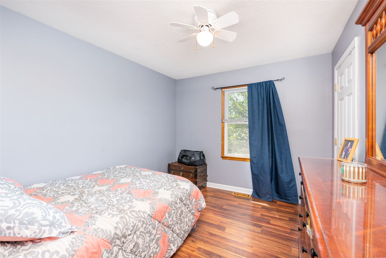 104 Buckboard Road Waynesboro, VA 22980 - Photo 29 of 43 a bedroom with a bed and a chandelier