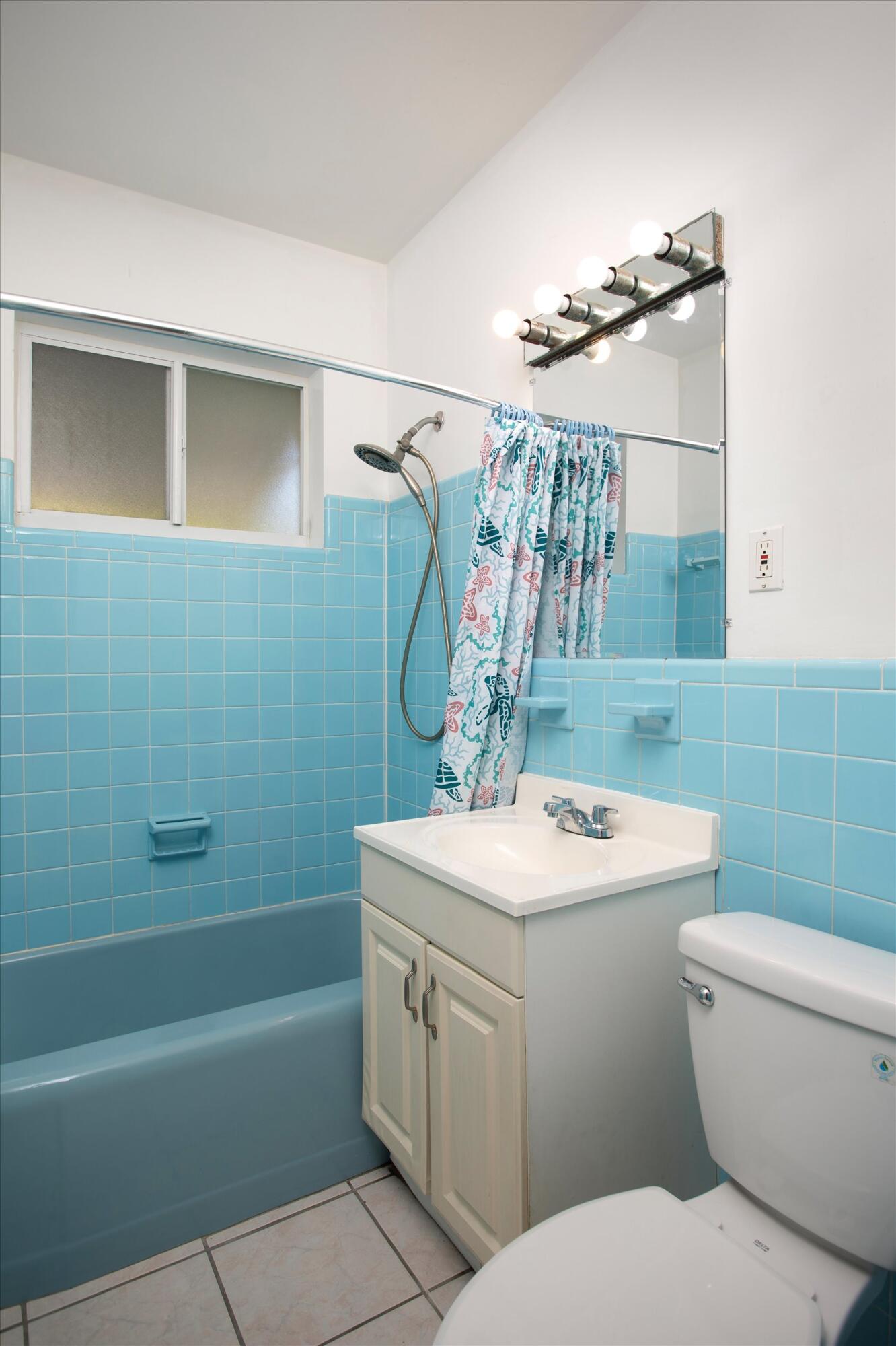 1228 11th Street Key West, FL 33040 - Photo 13 of 17 a bathroom with a sink a toilet and shower