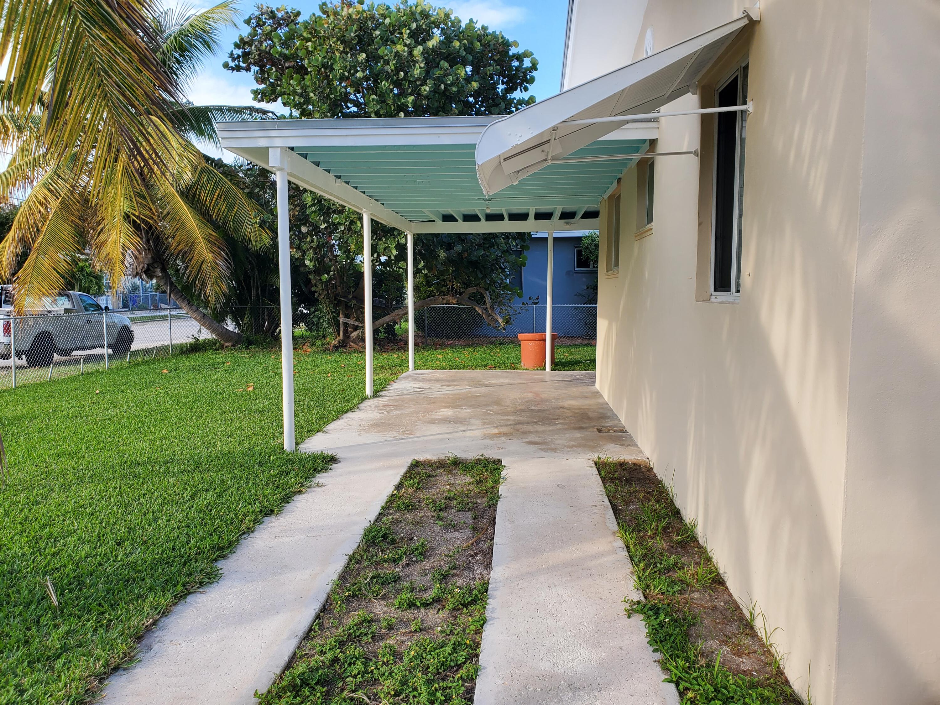 1228 11th Street Key West, FL 33040 - Photo 16 of 17 a view of a backyard with potted plants