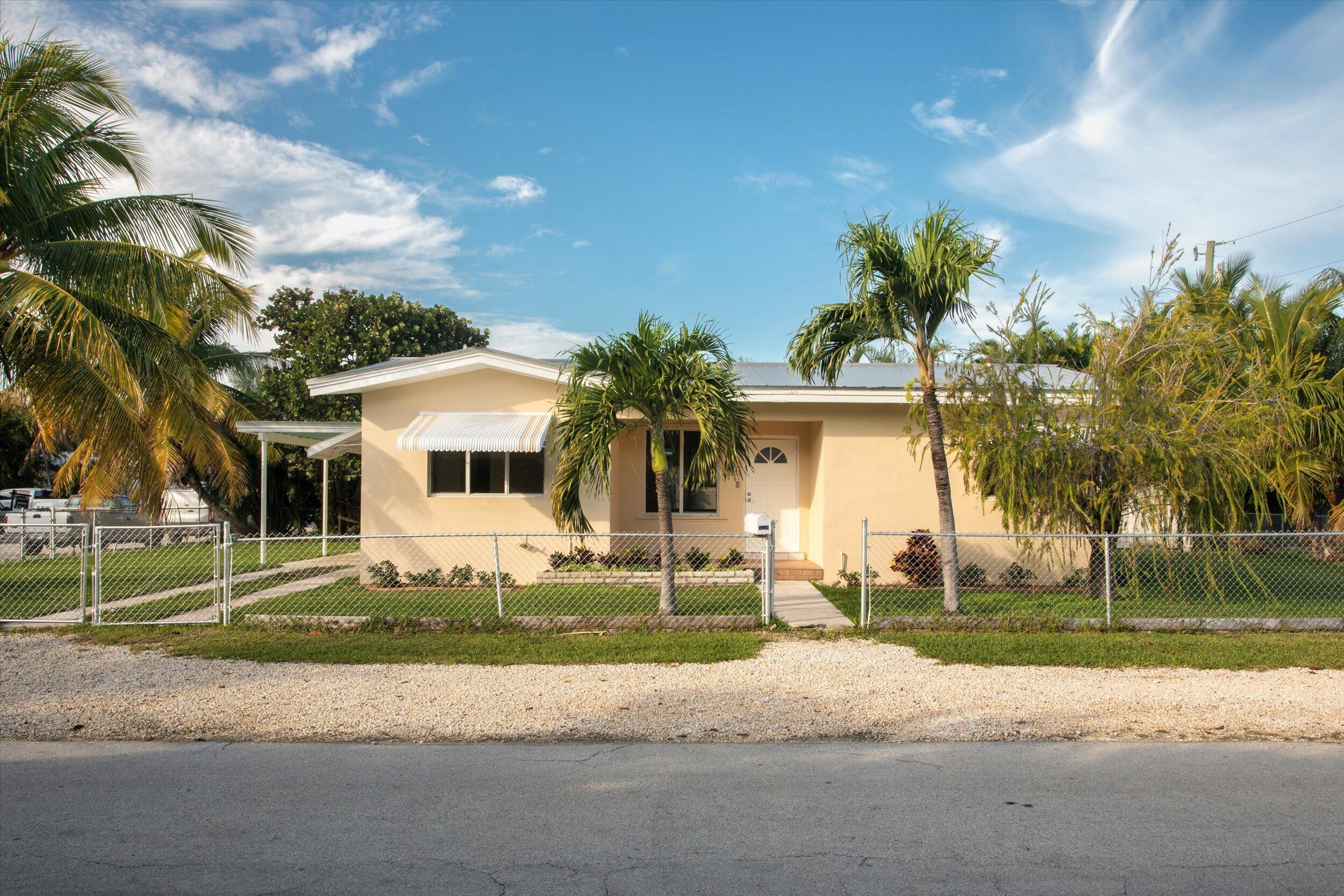 1228 11th Street Key West, FL 33040 - Photo 2 of 17 a white house with a yard and parking space