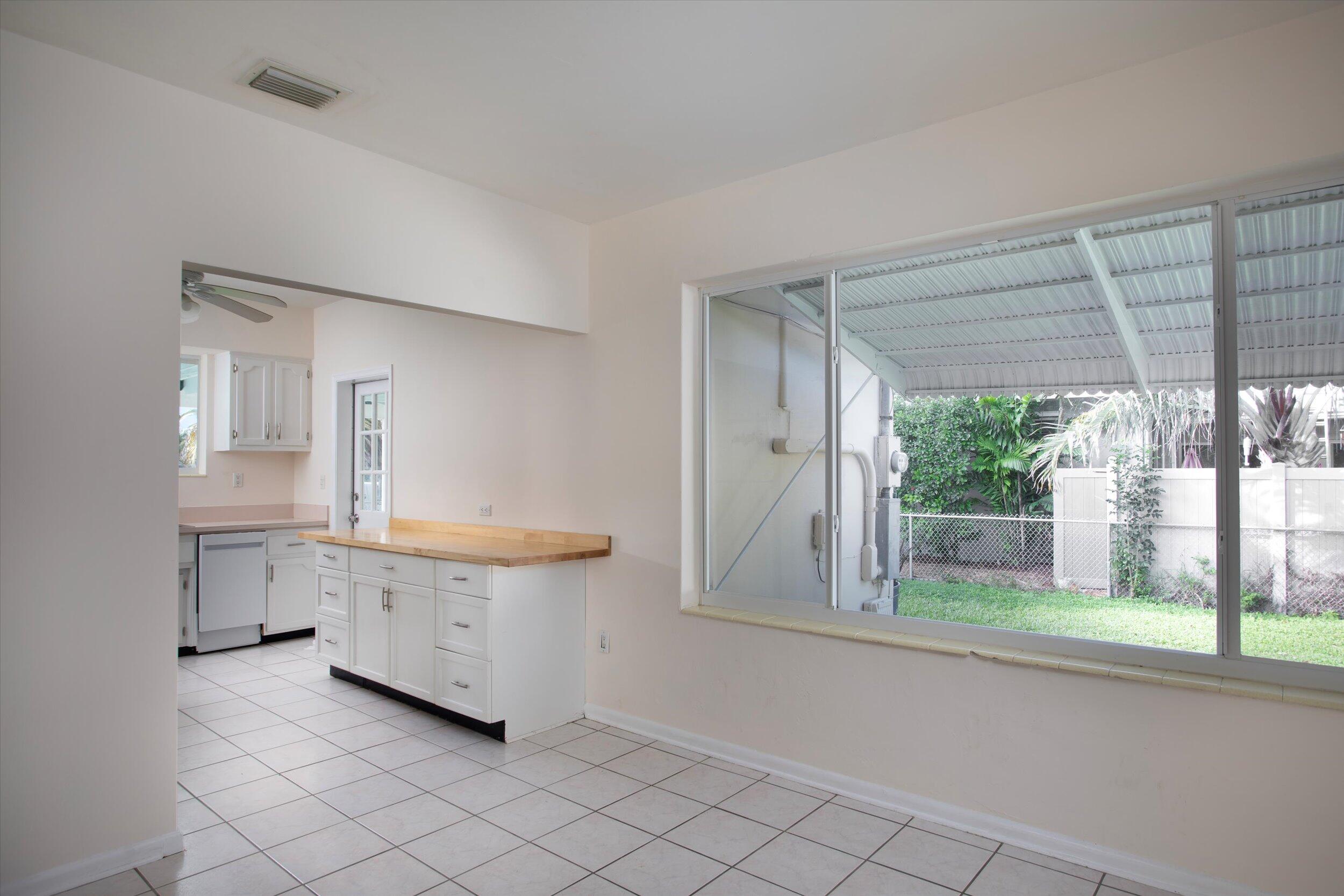 1228 11th Street Key West, FL 33040 - Photo 5 of 17 a bathroom with a sink a mirror and a bathtub next to a window