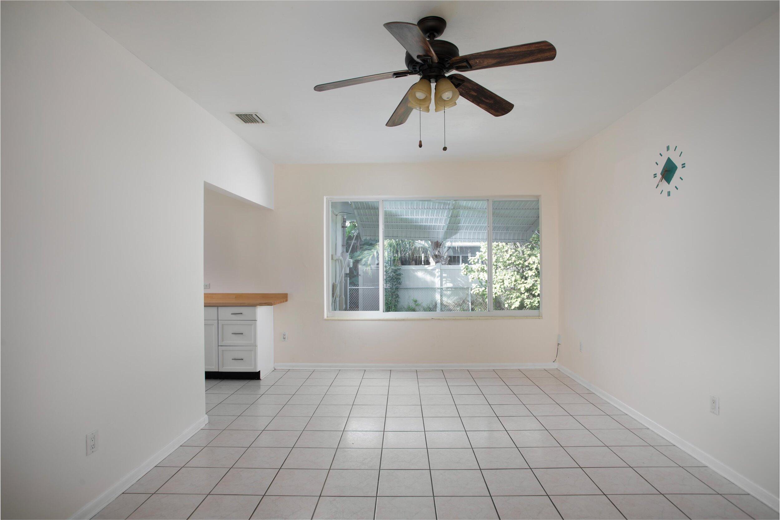 1228 11th Street Key West, FL 33040 - Photo 6 of 17 an empty room with windows and ceiling fan