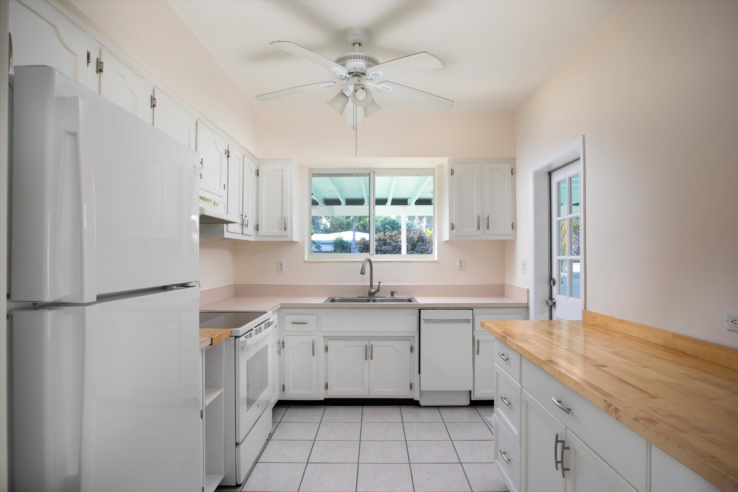 1228 11th Street Key West, FL 33040 - Photo 7 of 17 a kitchen with a sink appliances cabinets and a window