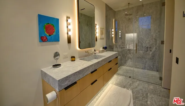 a bedroom with a bed and a mirror