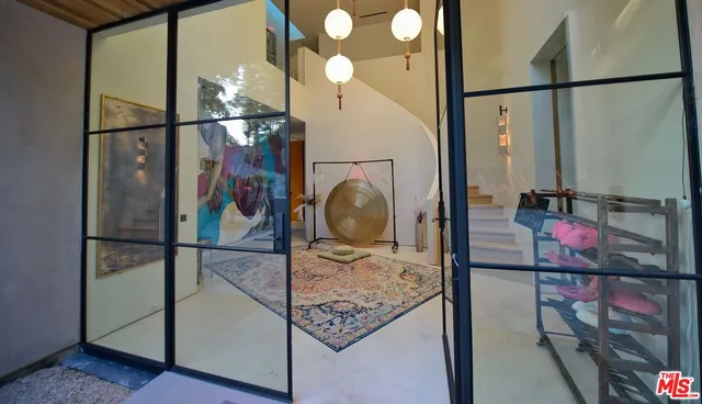 a very nice looking dining room with a large window and stainless steel appliances