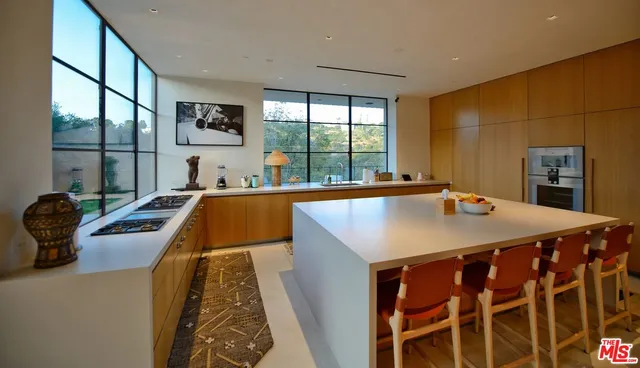 a kitchen with a sink and a stove top oven