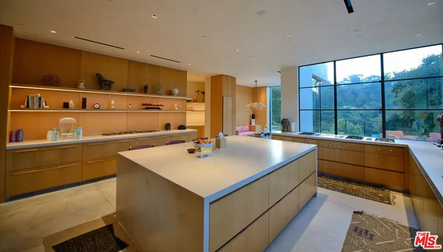 a living room with furniture and a floor to ceiling window