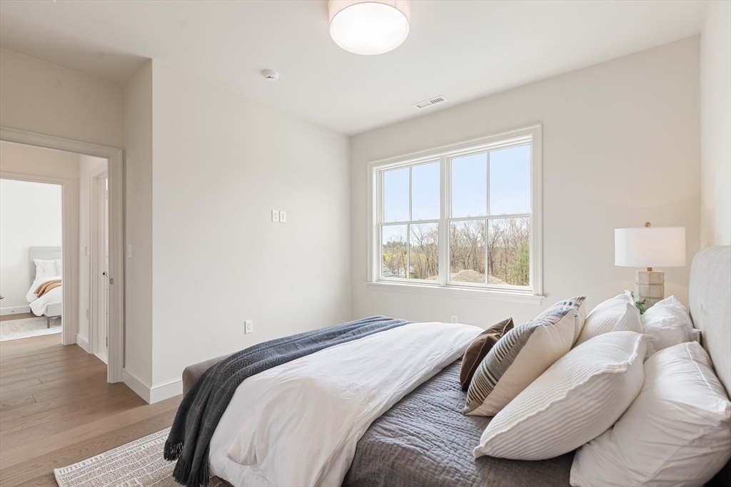 8 Common Court, Unit 8 Lexington, MA 02421 - Photo 24 of 34 a bed sitting in a bedroom next to a window