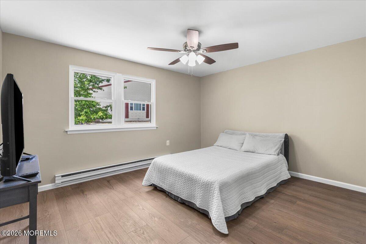 16 D Spring Street, Unit 50 Whiting, NJ 08759 - Photo 20 of 28 a bedroom with a bed and a flat screen tv