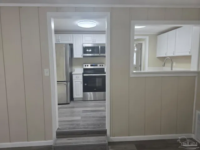 a kitchen with stainless steel appliances a refrigerator and cabinets