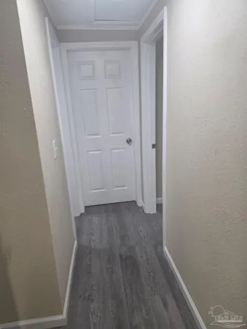 a view of a room with wooden floor