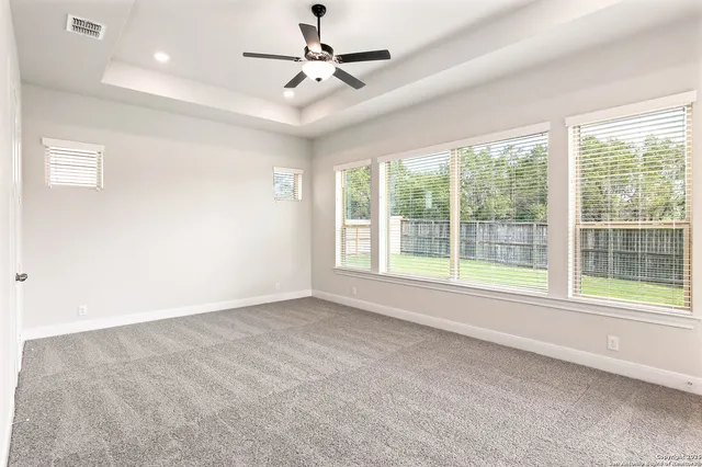 a view of room with a ceiling fan and window