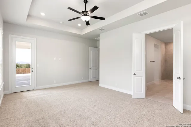 an empty room with fan and a ceiling fan