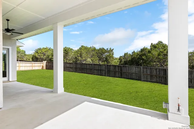 a view of an empty room with a window and brick walls