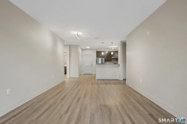 a view of a big room with wooden floor and an empty space