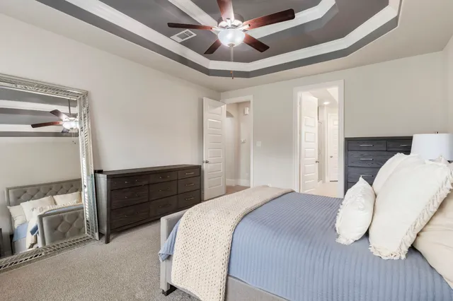 a bedroom with a bed and a chandelier