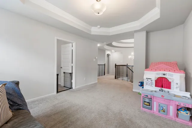 a living room with furniture and a chandelier