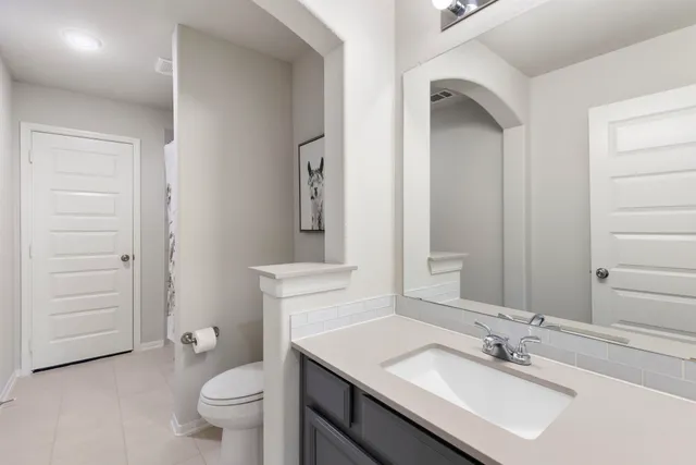 a view of a patio with couches table and chairs under an umbrella