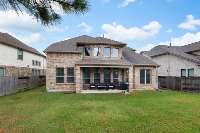 a front view of a house with a garden and yard