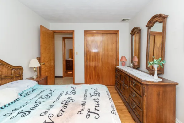 a bedroom with a bed and a dresser in it