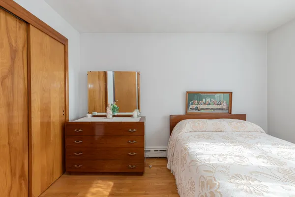 a bedroom with a bed and a dresser