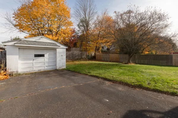 a front view of house with yard and green space