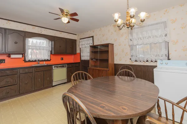 a dining room with a table chairs and a chandelier
