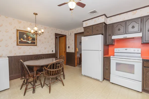 a kitchen with stainless steel appliances a refrigerator and a stove top oven