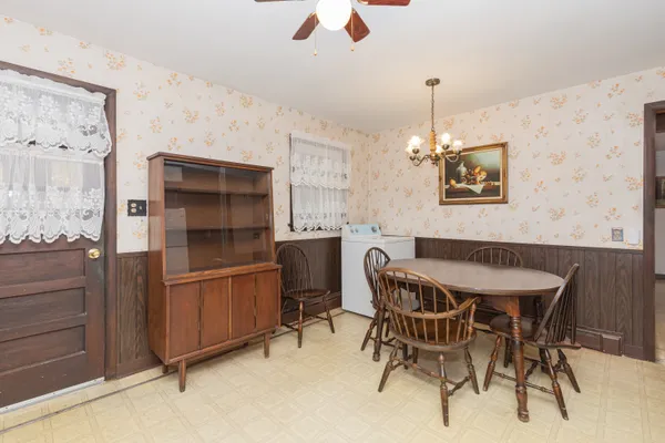 a kitchen with stainless steel appliances kitchen island granite countertop furniture and a refrigerator
