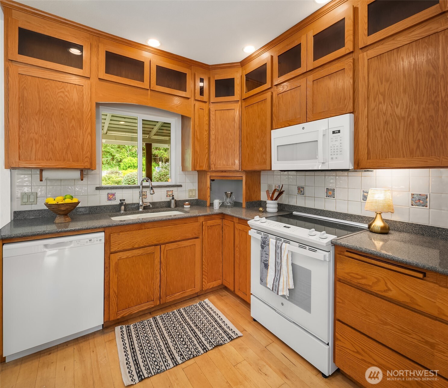 22113 Dockton Road Southwest Vashon, WA 98070 - Photo 26 of 40 a kitchen with stainless steel appliances granite countertop a stove a sink and a microwave